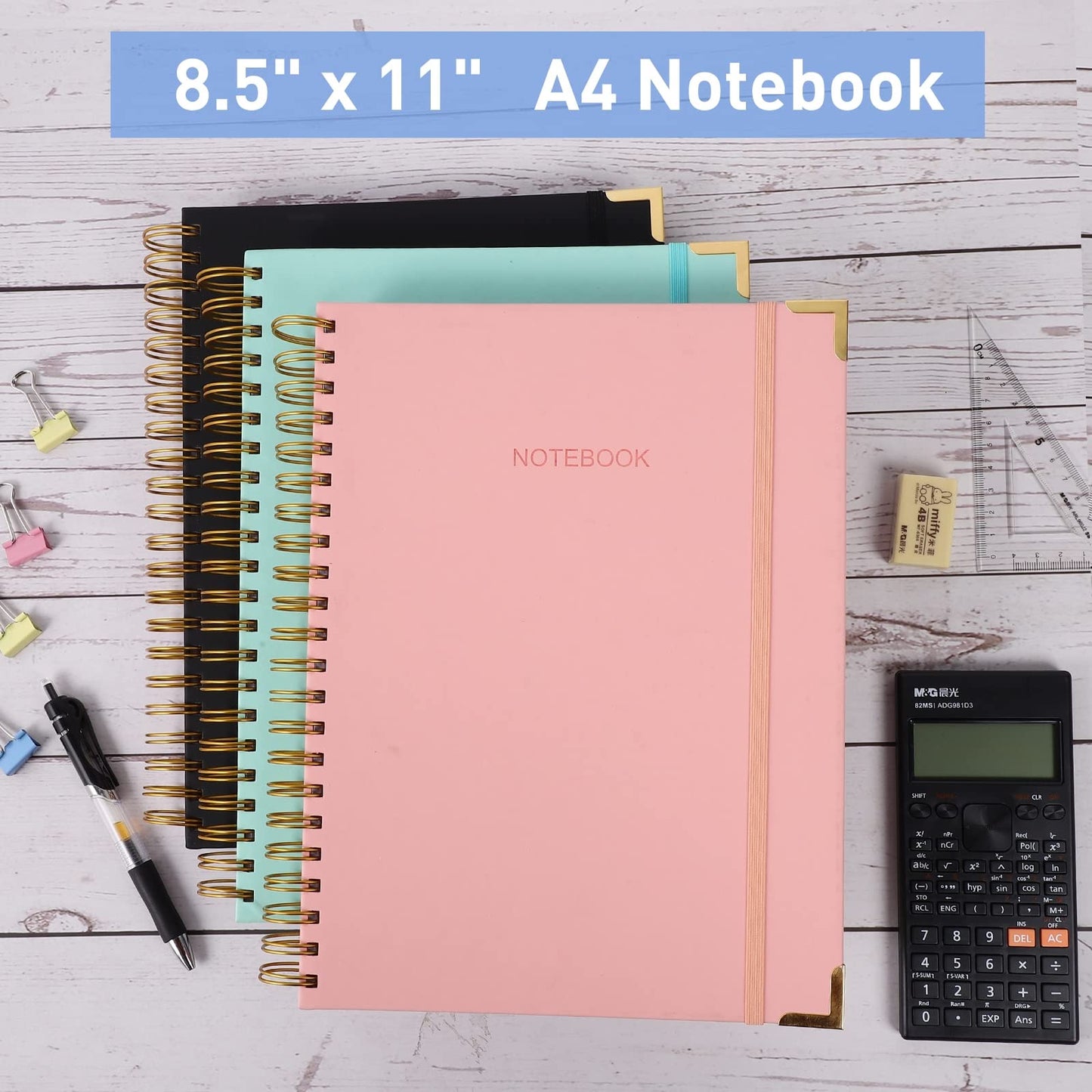 Spiral notebooks on a desk with pens and calculator.