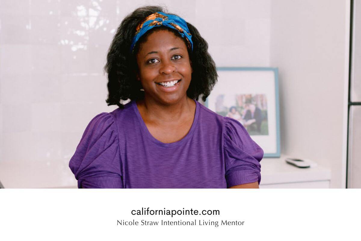 Nicole S., Intentional Living Coach, smiling while working at a laptop in her home office, representing the California Pointe brand.